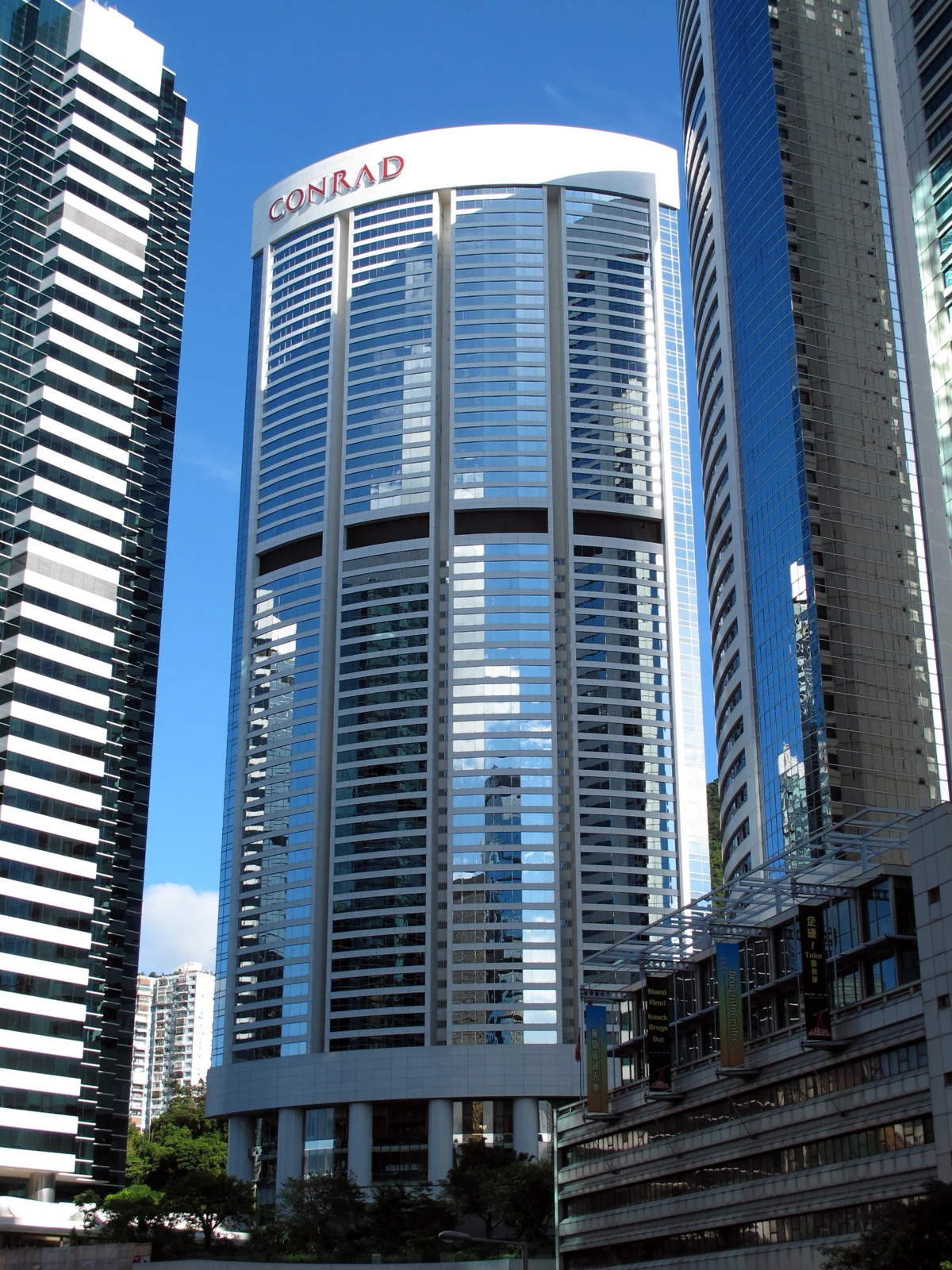 Conrad Hong Kong tower with its red Conrad sign among the buildings of Pacific Place.