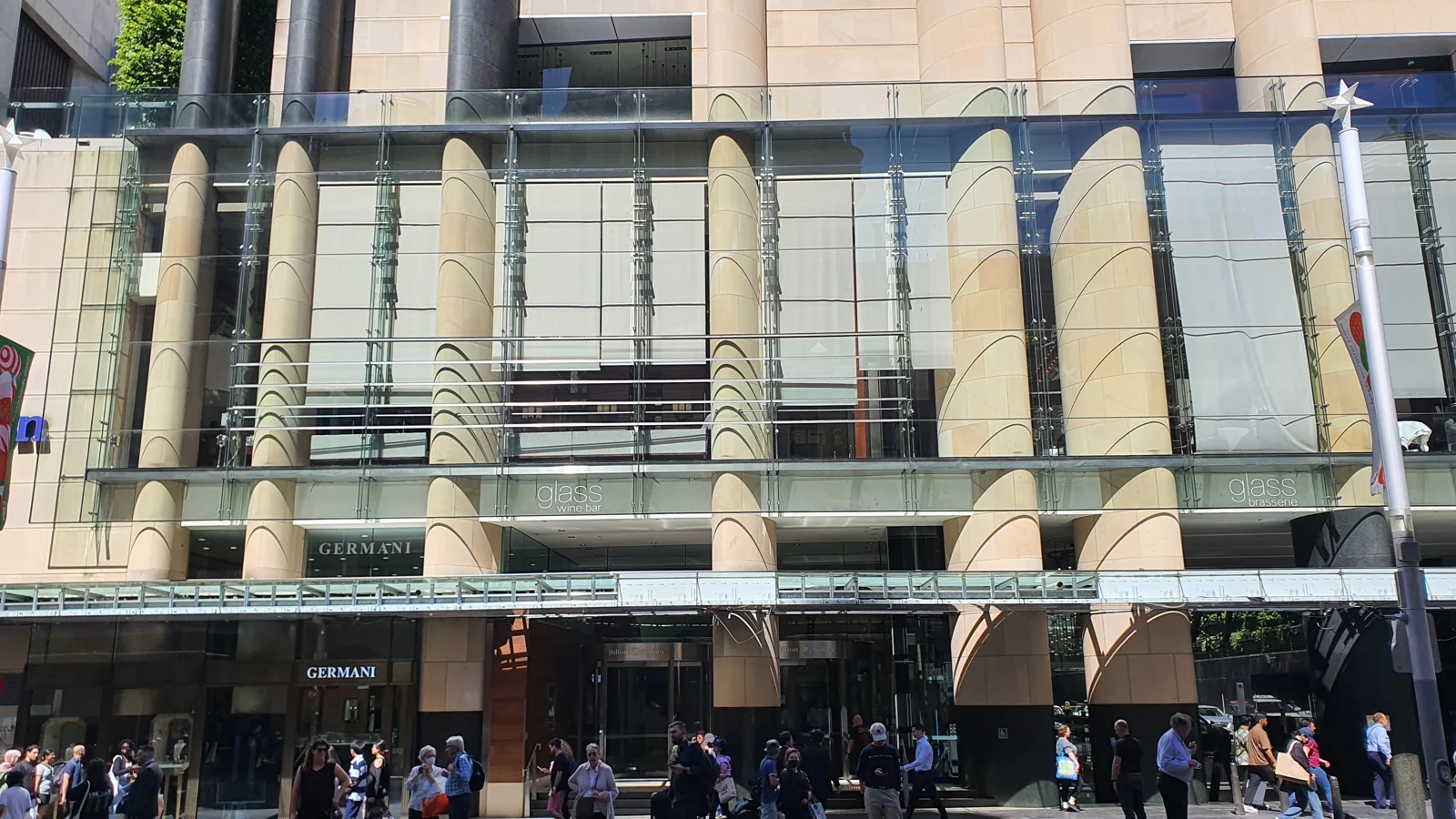 Glass-fronted George Street entrance and facade of Hilton Sydney.
